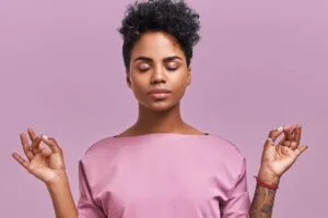 Lady in pink practising meditation