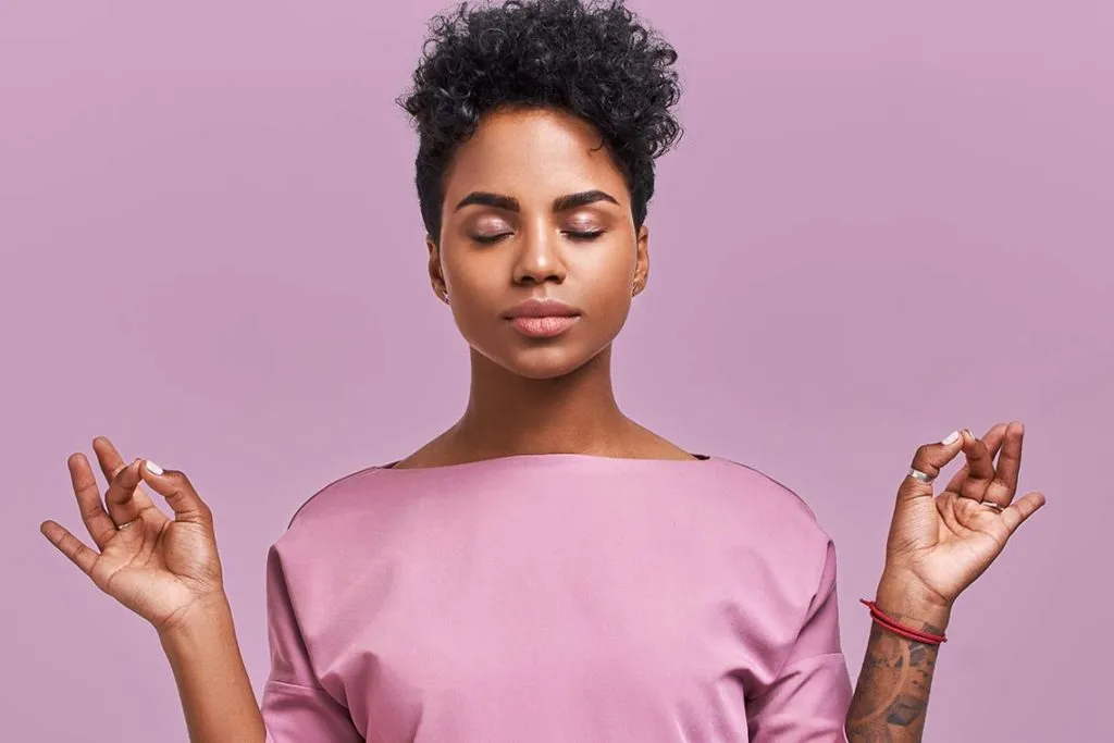 Lady in pink practising meditation